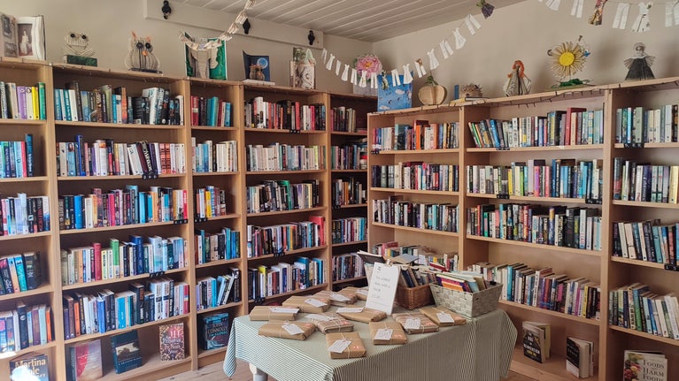 Shelves of second-hand bookshop in Laundry Cottage at Ightham Mote